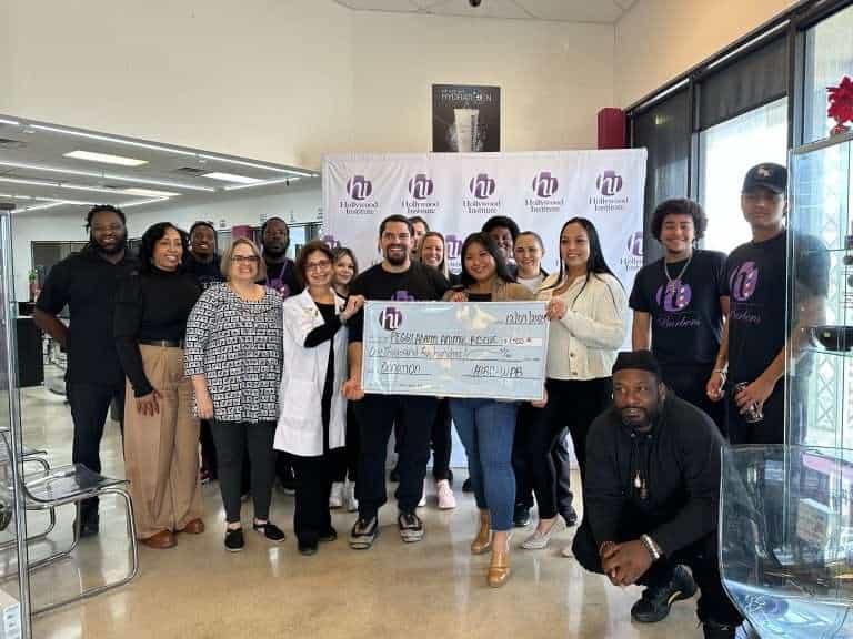 Community volunteers presenting a donation check at Peggy Adams Animal Rescue.