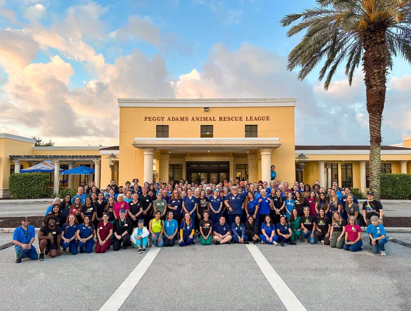 Group of staff and volunteers at Peggy Adams Animal Rescue League building.
