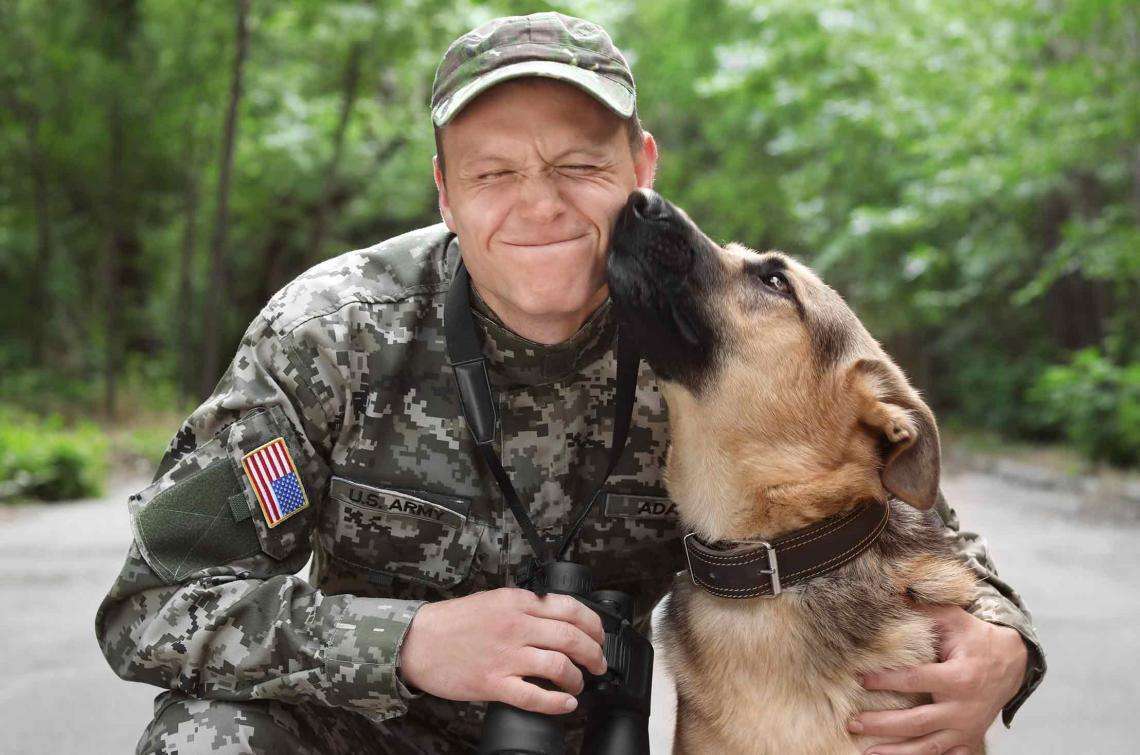 U.S. Army Soldier hugging dog