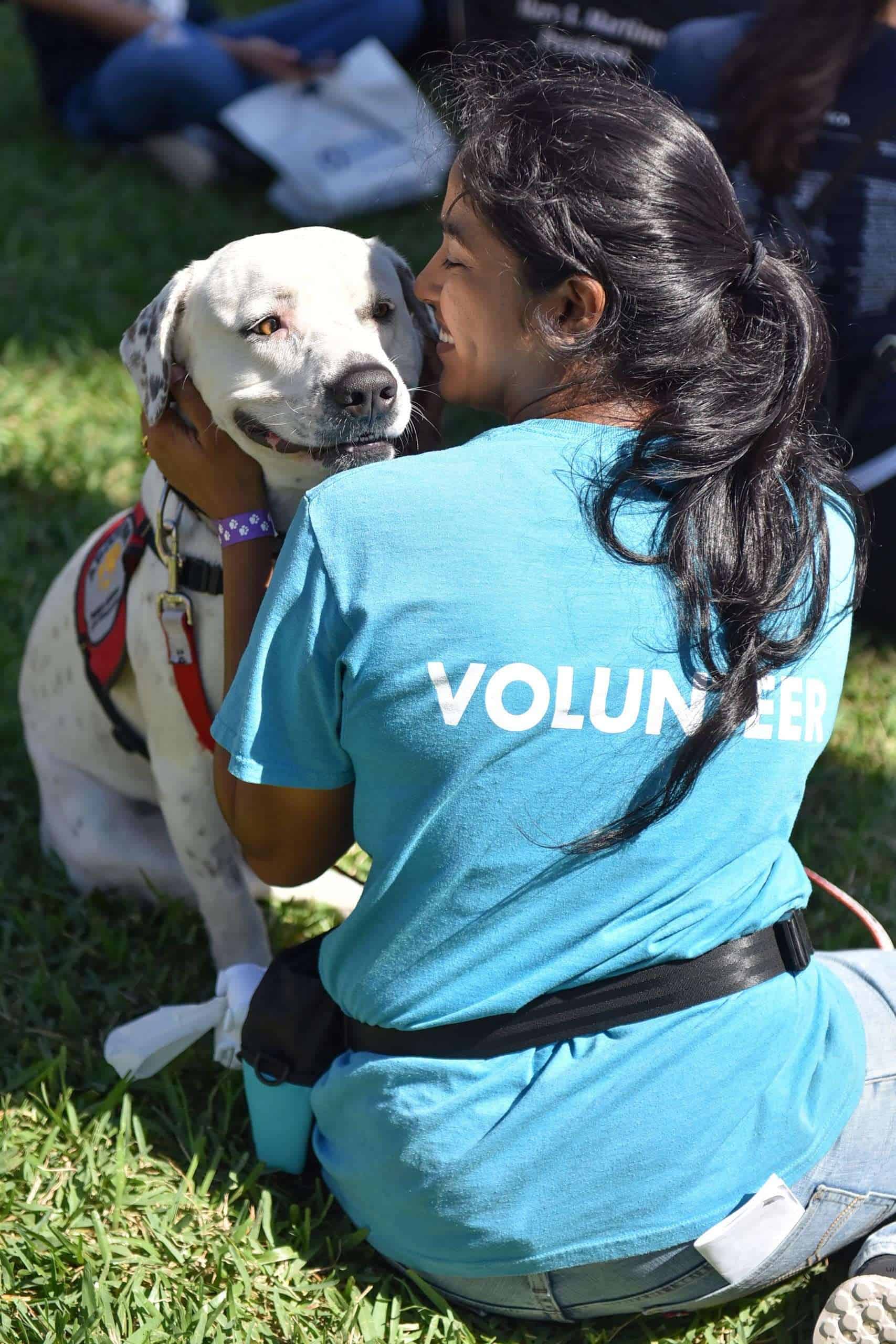 Woman with dog during volunteering at Peggy Adams