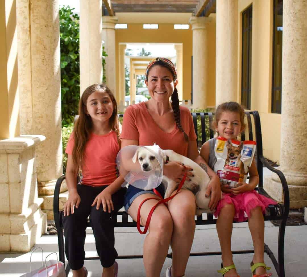 Dog and children at Peggy Adams Animal Rescue, happy with their new pet.