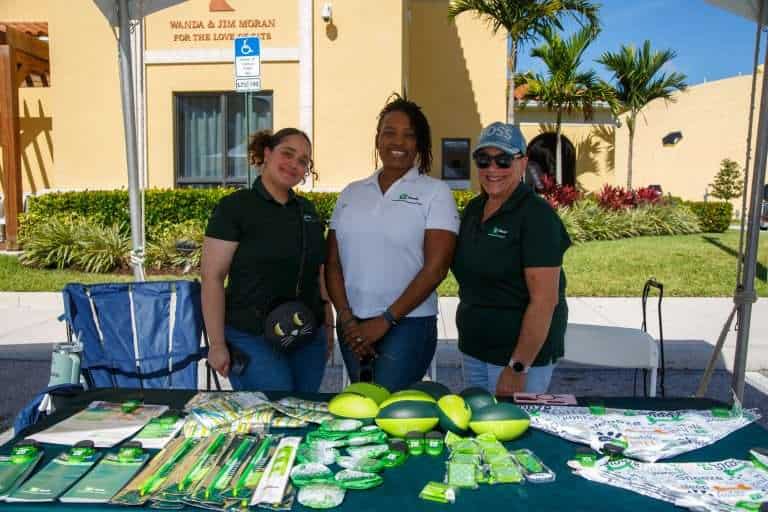 Peggy Adams staff and volunteers at a pet adoption event outdoors.