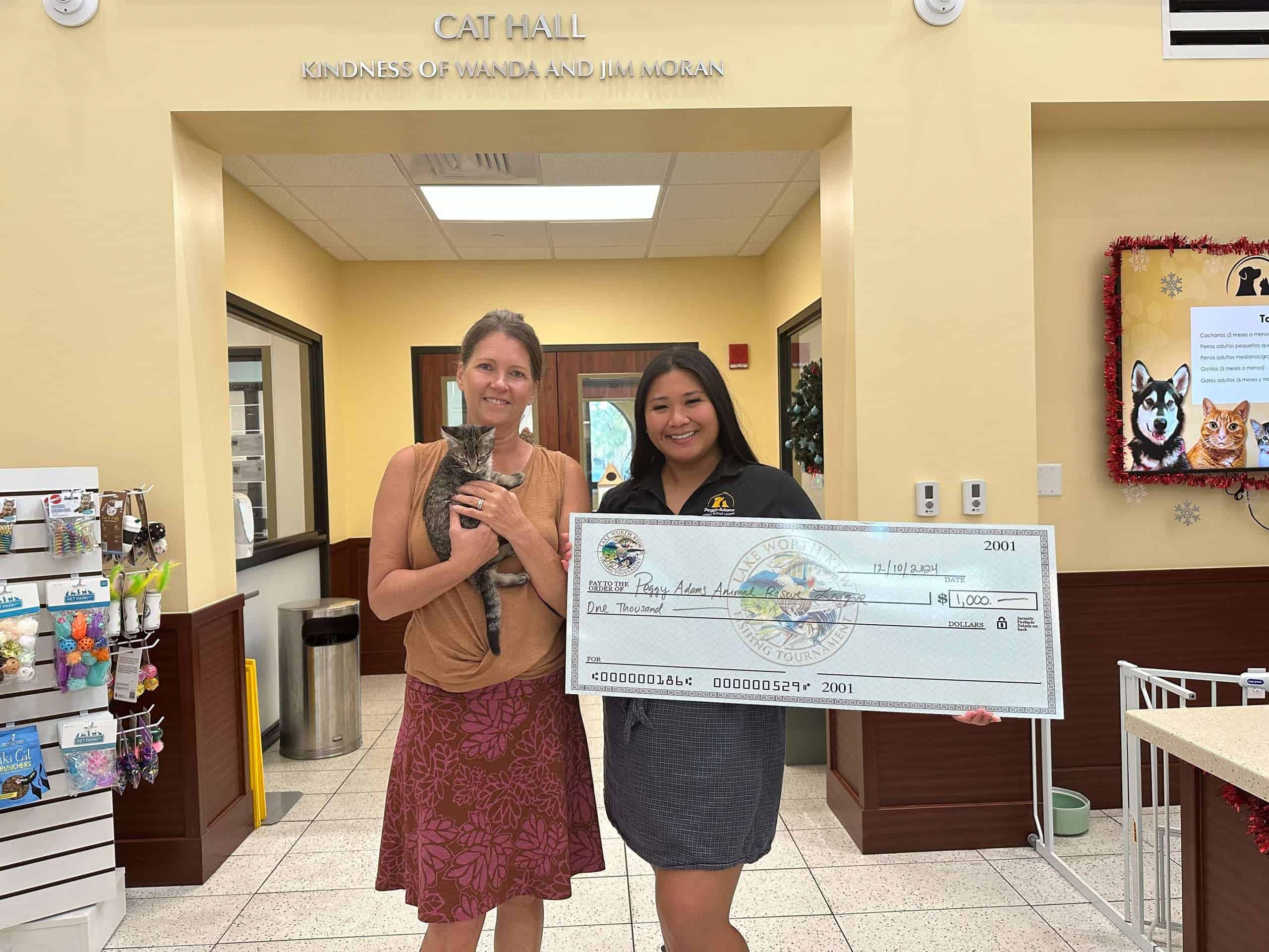Pet adoption donation check presentation at Peggy Adams Animal Rescue.