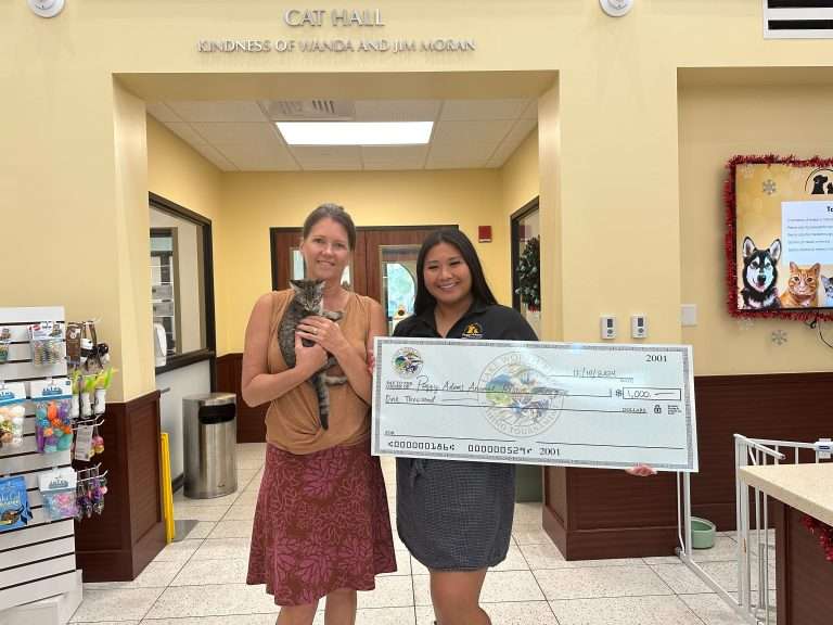 Pet adoption donation check presentation at Peggy Adams Animal Rescue.