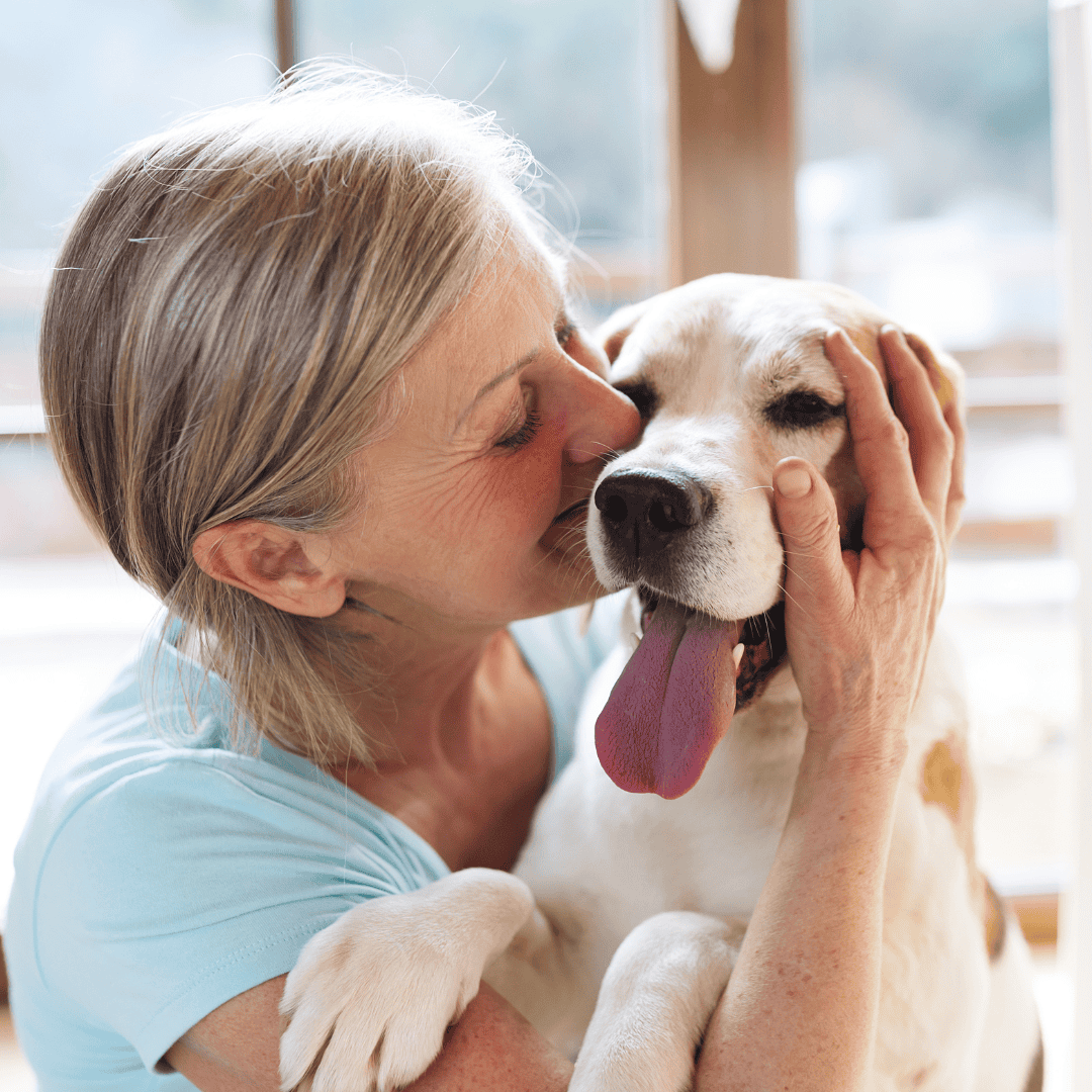 Woman hugging her happy dog at Peggy Adams Animal Shelter.