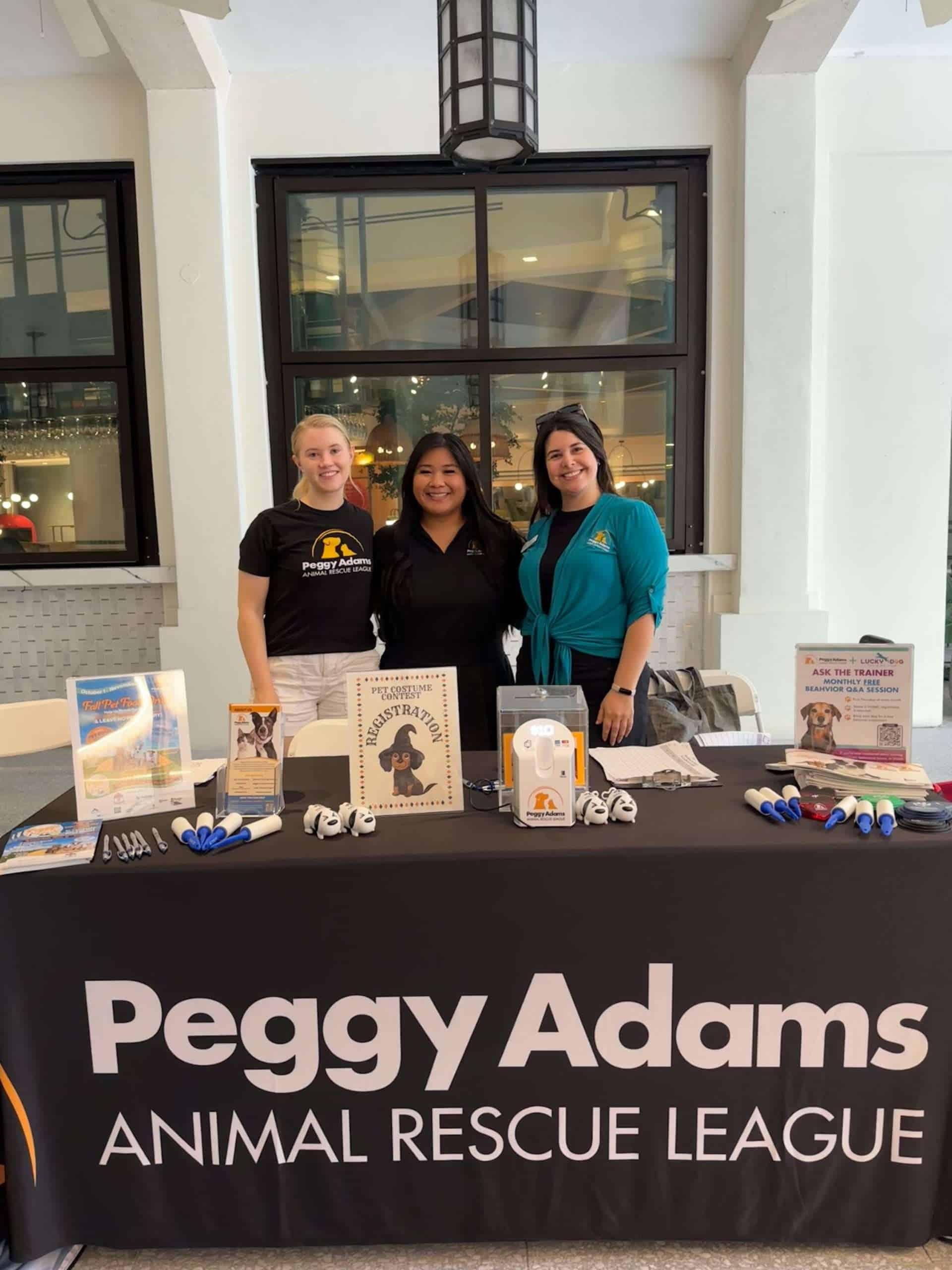 Adoptable pets and community outreach at Peggy Adams Animal Rescue League event.