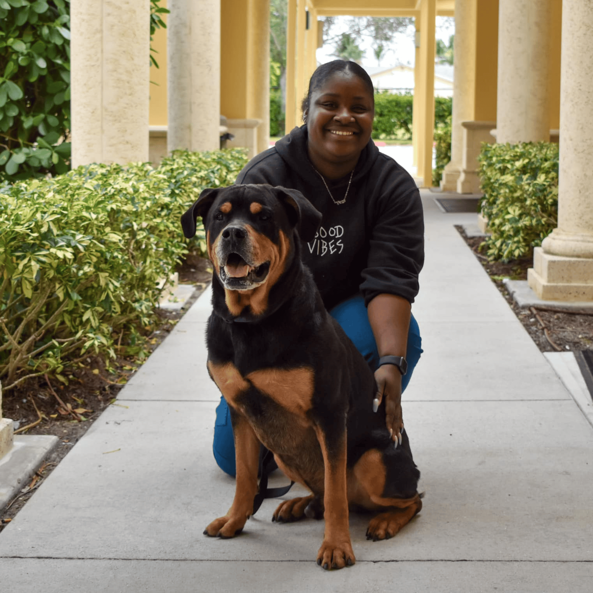 Woman with Rottweiler dog at Peggy Adams animal shelter.