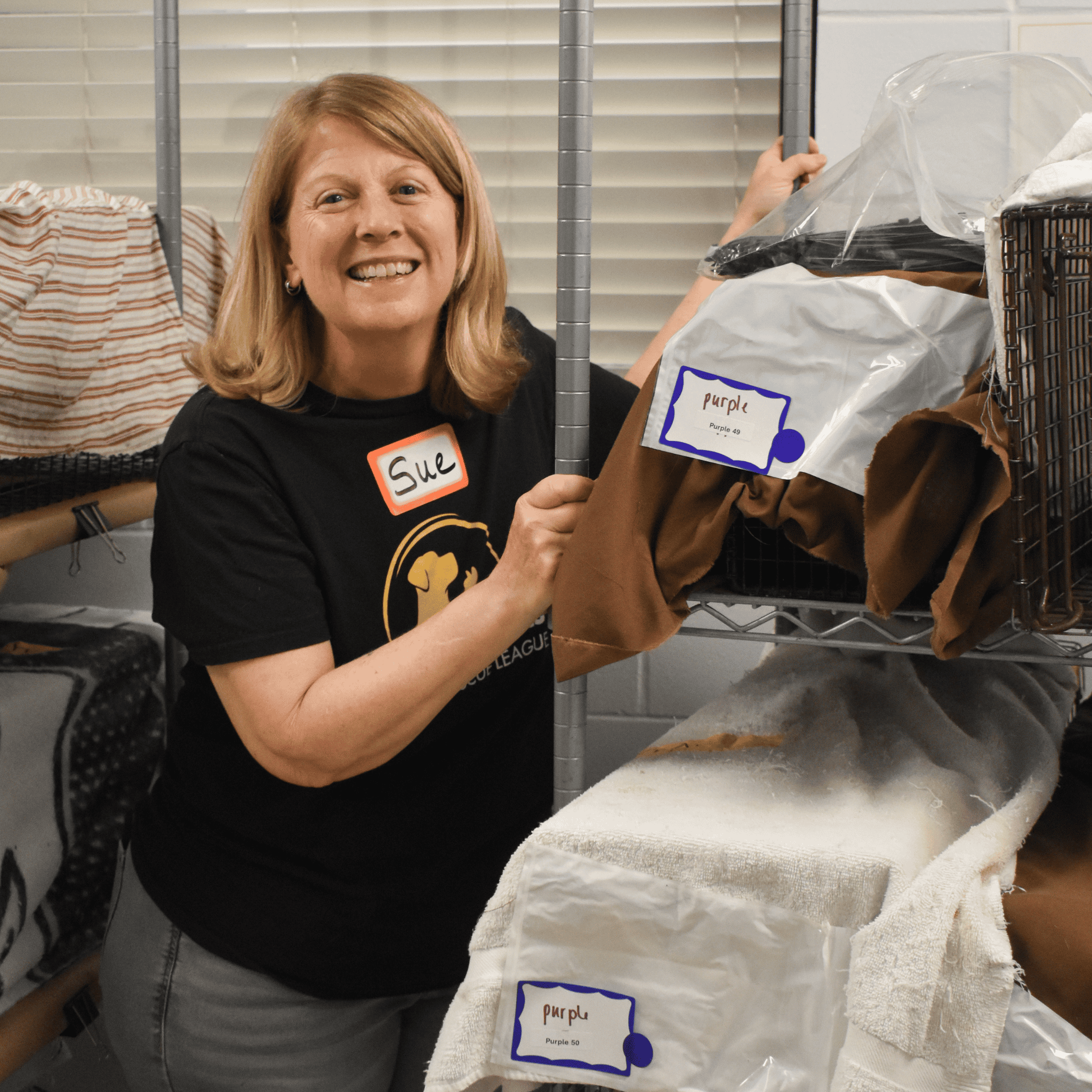 Volunteer organizing pet supplies at Peggy Adams animal shelter.