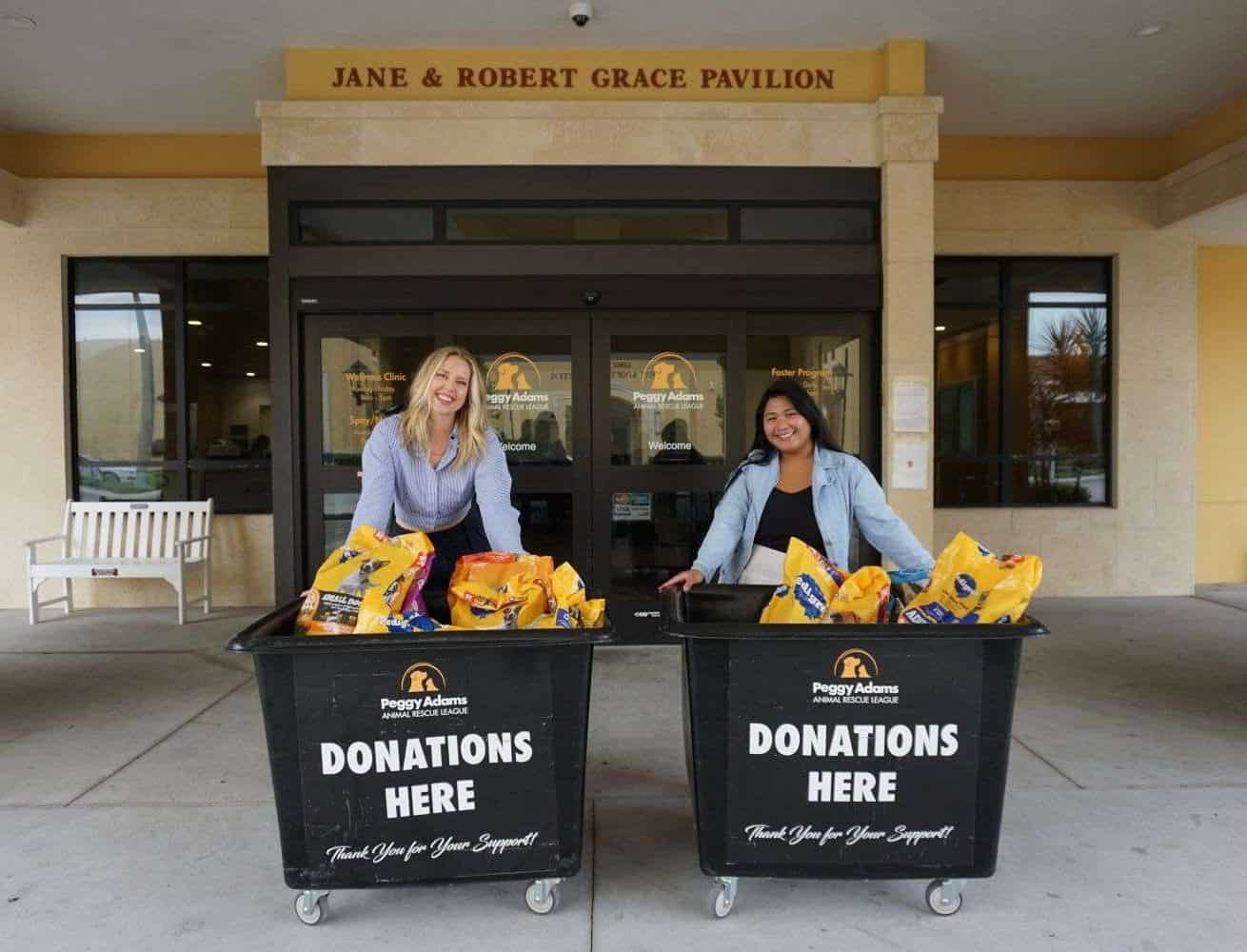 Pet donations collection at Peggy Adams Animal Rescue, featuring two smiling women with donation bin.
