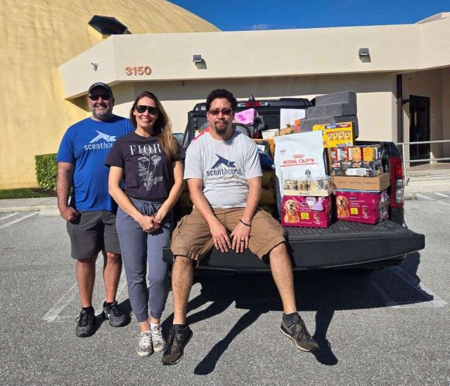 Team of volunteers with pet supplies at Peggy Adams Animal Rescue Foundation.
