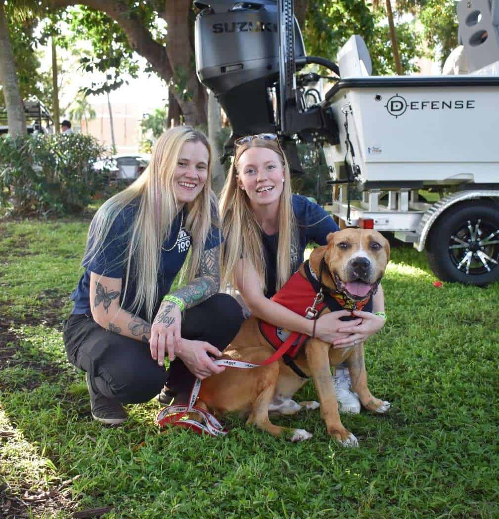 Service dog with handler and volunteers at Peggy Adams Animal Rescue.